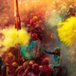People celebrating Holi festival in India throwing colorful powder in a vibrant crowd
