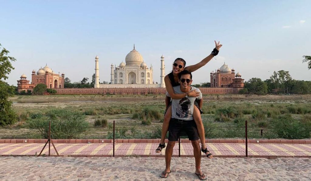 Foreign tourists posing in front of Taj Mahal during India tour – Taj Mahal travel experience