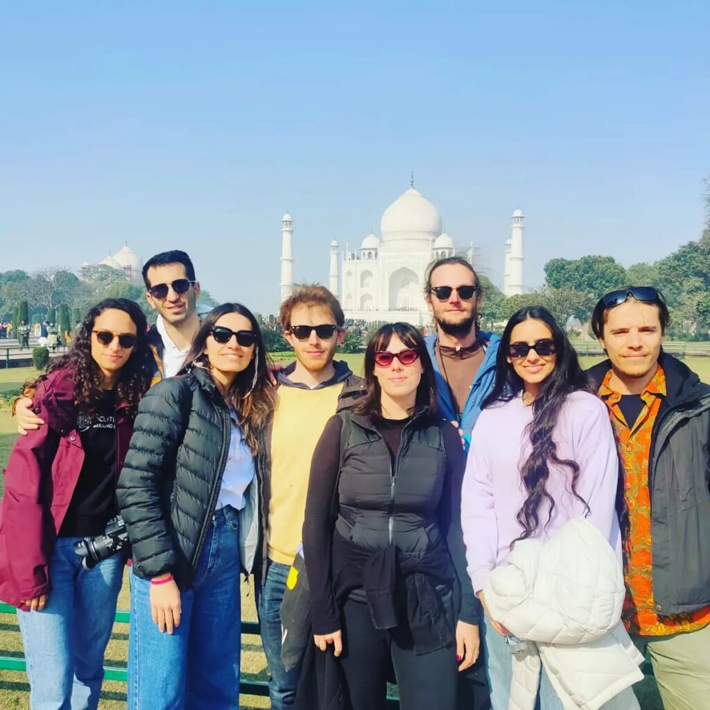 Tourists posing in front of the Taj Mahal in Agra, India