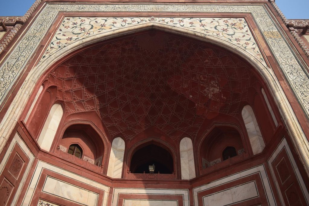The red sandstone Jawab building with white marble domes on the eastern terrace of the Taj Mahal