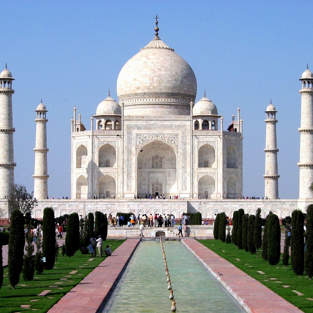 Iconic view of the white marble Taj Mahal with its central dome and four minarets in Agra